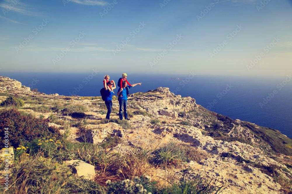Fototapeta premium family with kids hiking in summer mountains