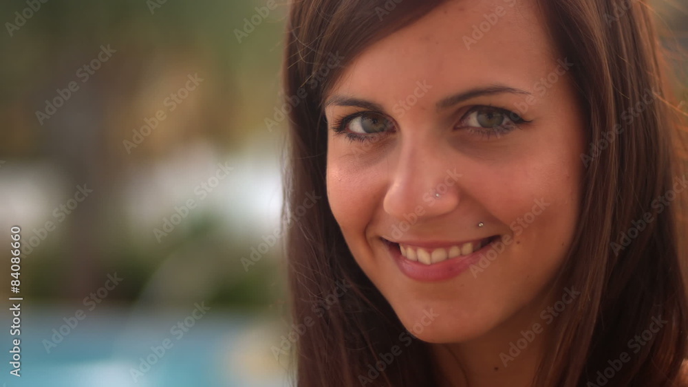 A close up of a cute young woman smiles into camera A close up of a cute young woman smiles into camera
