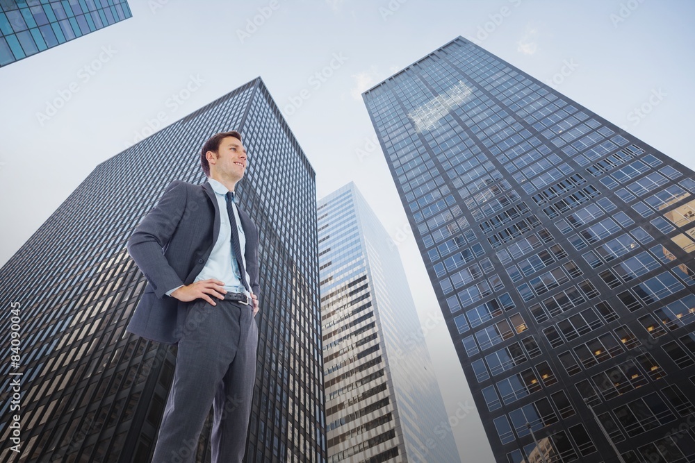Composite image of happy businessman with hands on hips Composite image of happy businessman with hands on hips