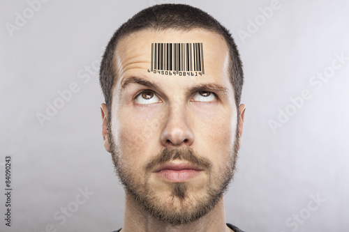 young man with a bar code on his forehead photo