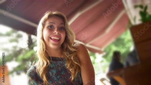 Young woman smiles at a cafe 