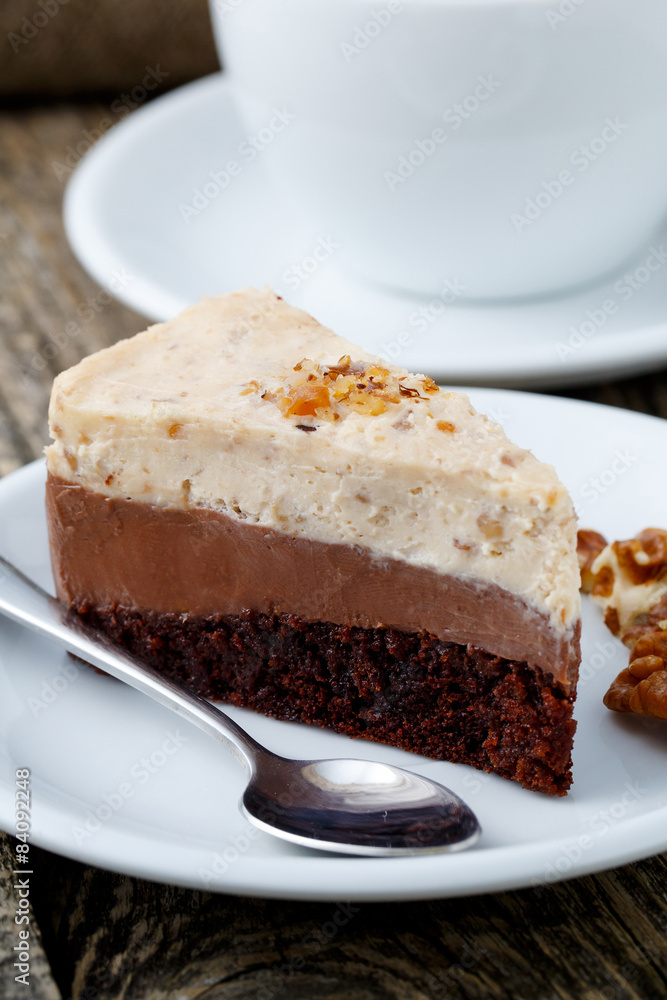 Tasty nuts cake with cup of coffee on wooden background. Tasty nuts cake with cup of coffee on wooden background.