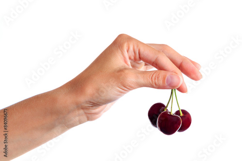 Fresh sweet cherries in the women's hand, isolated