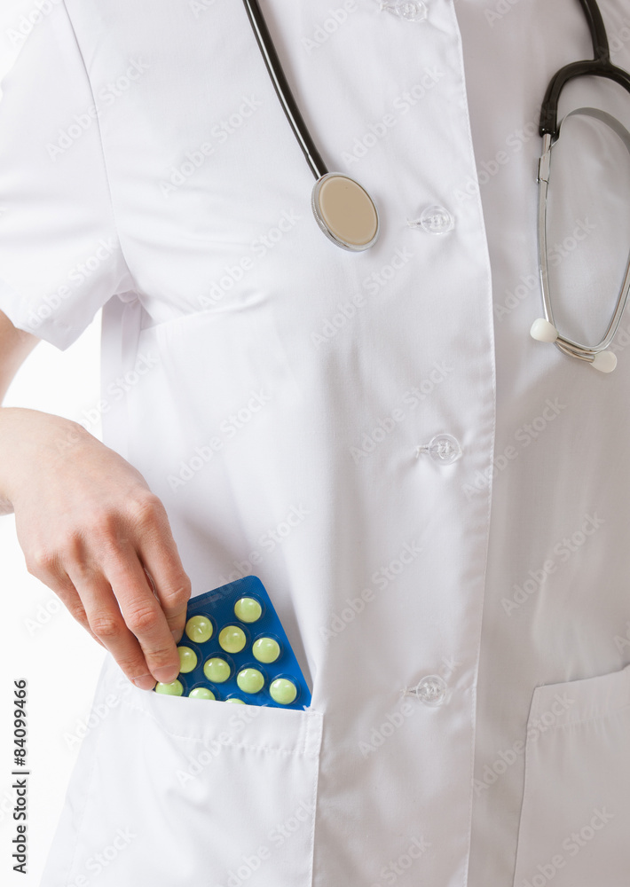 Doctor's hand extracts tablets from a pocket Doctor's hand extracts tablets from a pocket