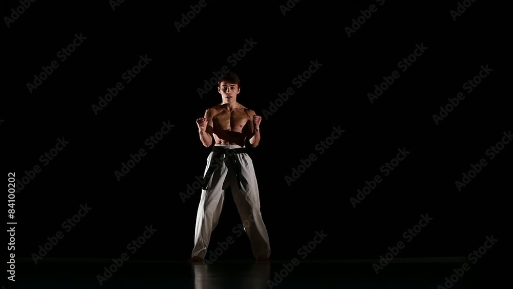 Man training taekwondo or karate Isolated on Black background Man training taekwondo or karate Isolated on Black background