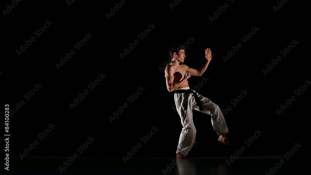 Man training taekwondo or karate jumping, high kick and fist Man training taekwondo or karate jumping, high kick and fist