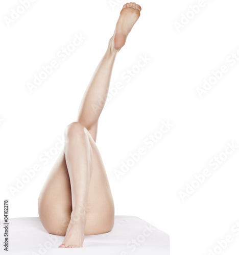 beautiful female legs raised in the air on a white background