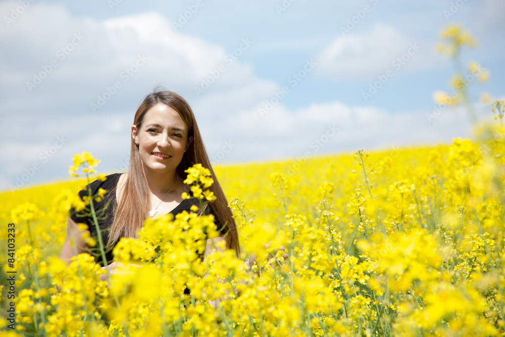 Woman posing in rape field Woman posing in rape field