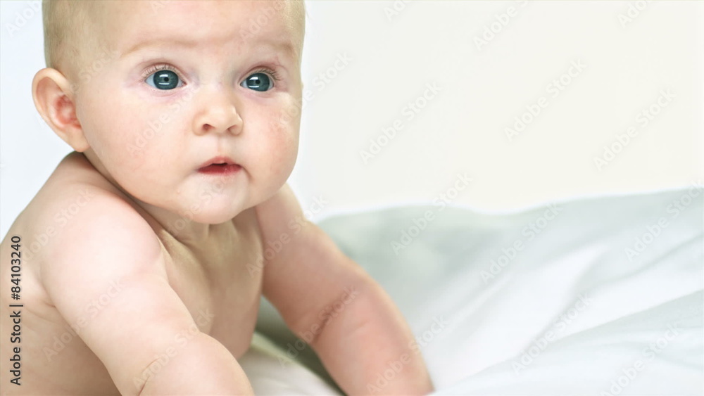 Baby with blue eyes and light hair moves and looks around Baby with blue eyes and light hair moves and looks around