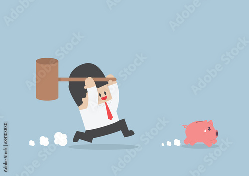 Businessman try to smashing piggy bank