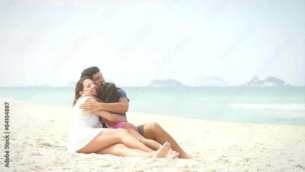 Brazilian Family sits on a beach in Brazil Brazilian Family sits on a beach in Brazil