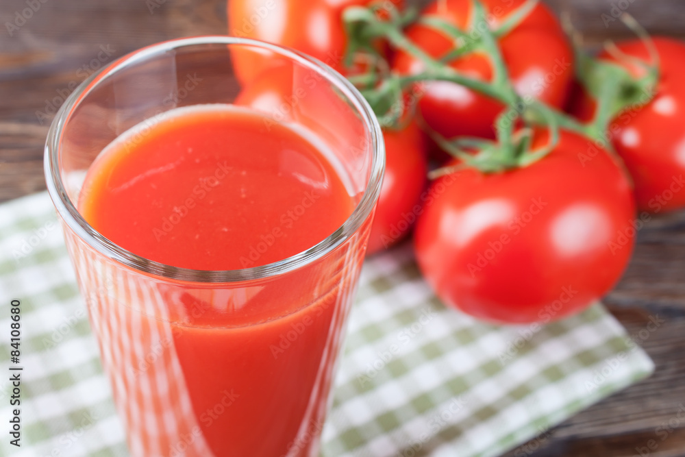 tomato juice and fresh tomatoes on wooden table tomato juice and fresh tomatoes on wooden table