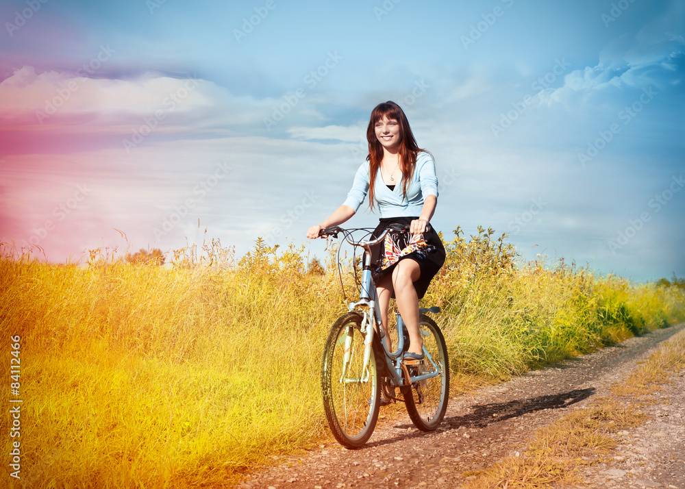 Funny girl with bicycle in a country road. Funny girl with bicycle in a country road.