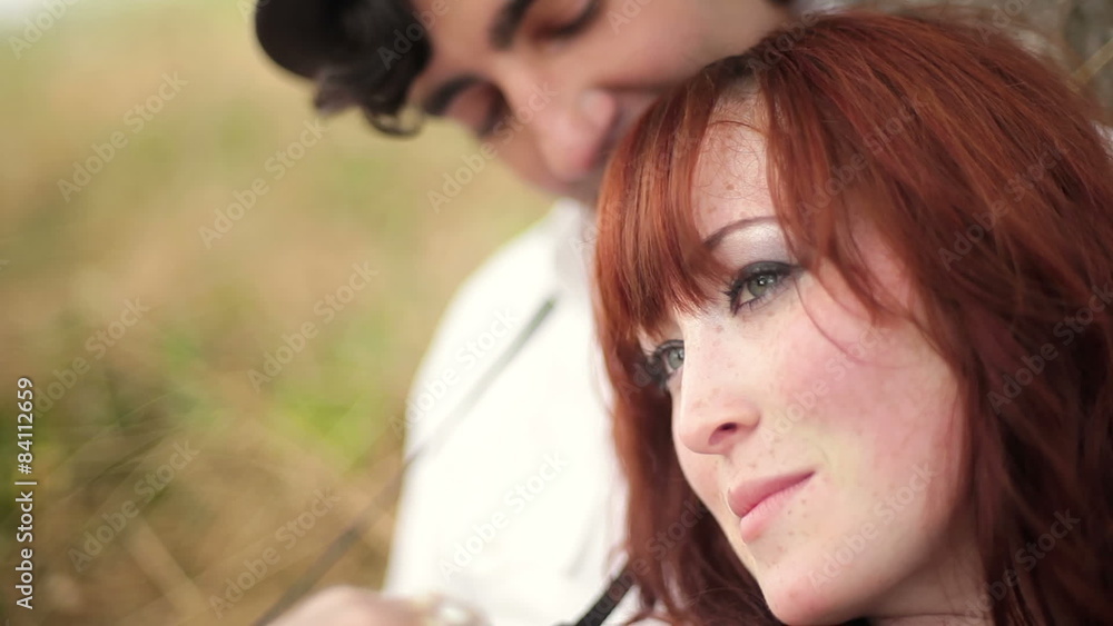 Cute couple lean against a tree holding each other. Close up shot. Cute couple lean against a tree holding each other. Close up shot.