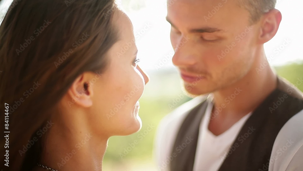 Attractive couple in soft light kiss. Medium shot. Attractive couple in soft light kiss. Medium shot.