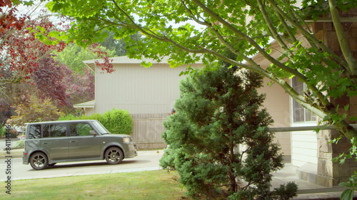 A family returns home from a picinic and walks from their driveway into their house photo