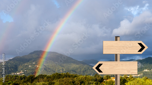 Vászonkép Landscape rainbow, signposts. LIfe metaphor sunshine, showers.