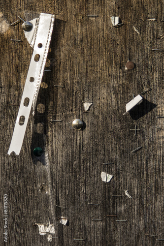 Decaying wooden background with tacks and staples 