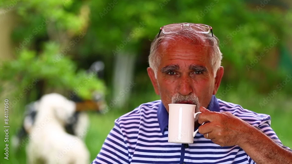senior man drinking coffee in a garden senior man drinking coffee in a garden