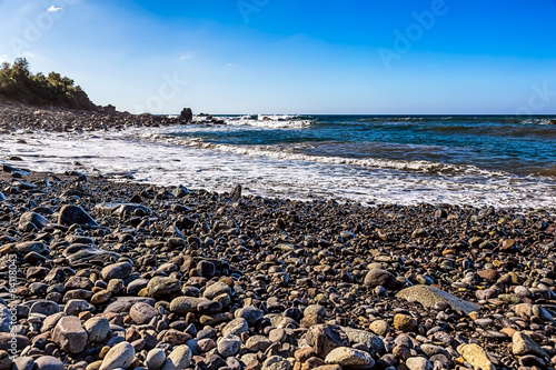 Wild stone beach on coast of ocean © xmagics