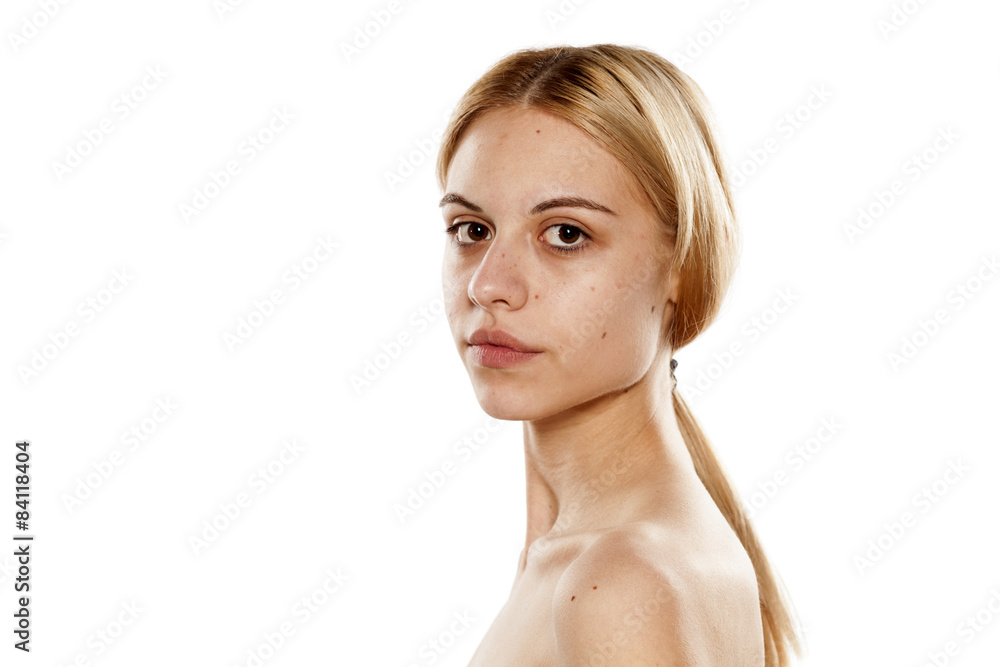 Fotografie a young serious woman without makeup on a white background