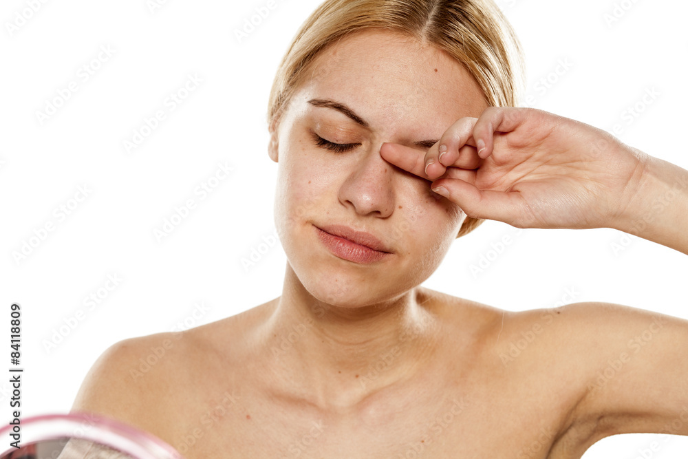 Beautiful Young Woman Rubs Her Eye With A Finger Stock Foto Adobe Stock 