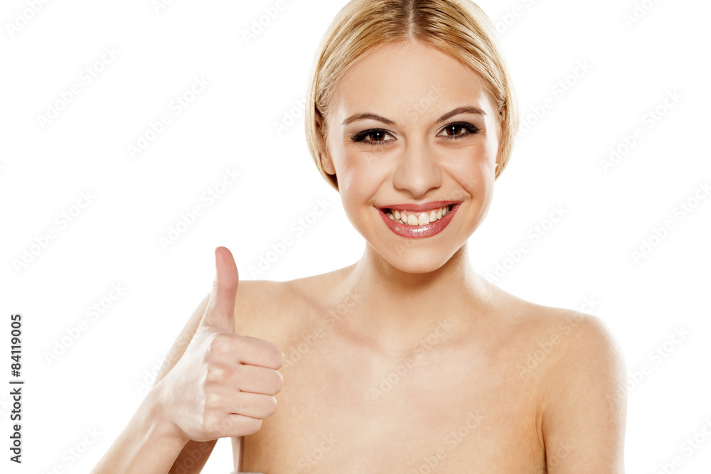 Beautiful smiling young woman showing thumbs up Beautiful smiling young woman showing thumbs up