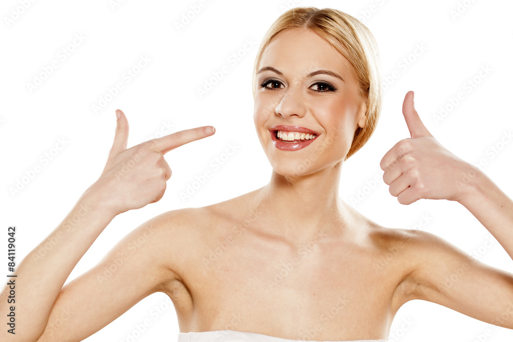 smiling girl pointing a finger at her self and showing thumbs up smiling girl pointing a finger at her self and showing thumbs up