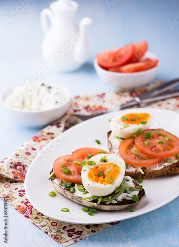 Rye toast sandwiches with egg and soft cheese