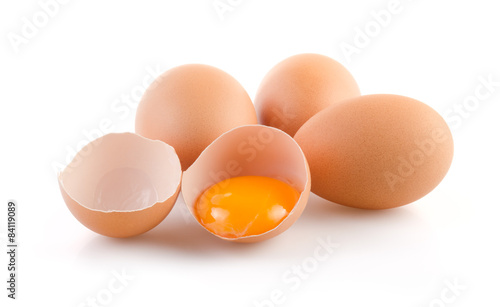 Brown Eggs with one broken on white background
