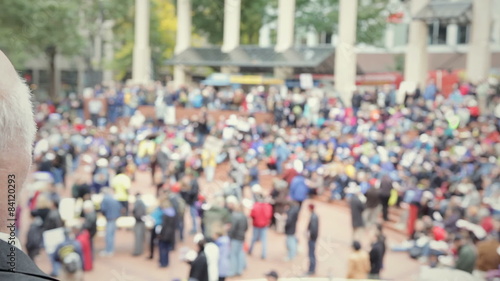 Wallpaper Mural A older bold man overlooks a large gathering of people in a downtown city Torontodigital.ca