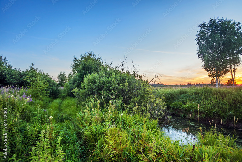 Summer sunset around field and river Summer sunset around field and river