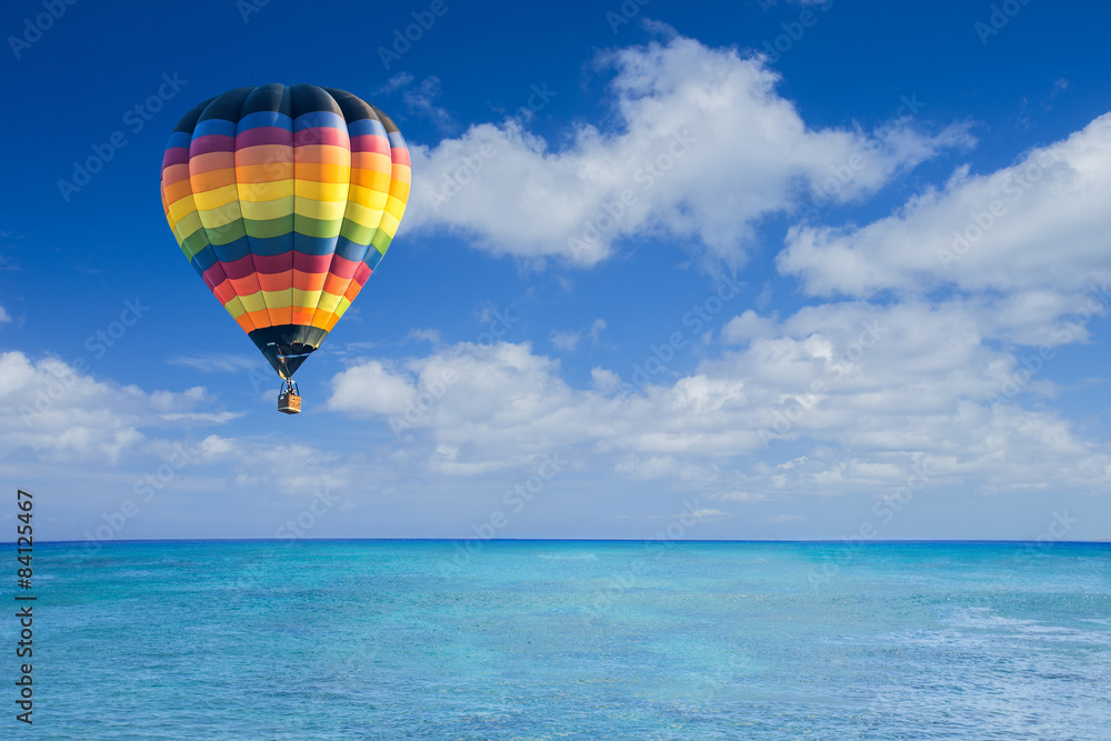 Fototapeta premium Colorful hot air balloon fly over the blue sea