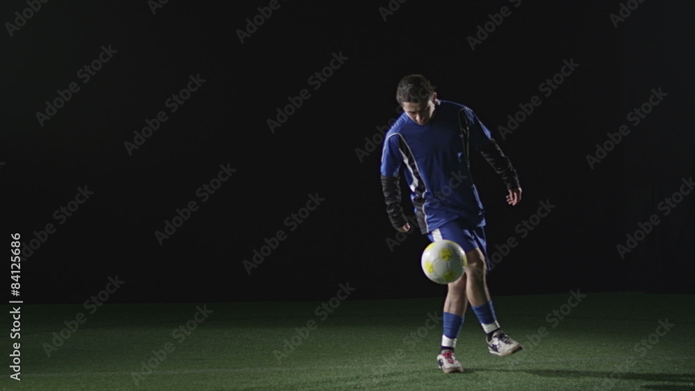 A soccer player does tricks with the ball A soccer player does tricks with the ball