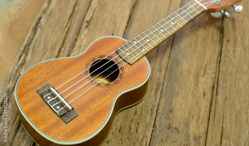 Close up ukuleles on wooden background.