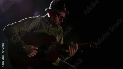 Close up of man's hands playing guitar