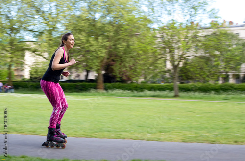 panning shot of a woman on rollerblades © michael spring