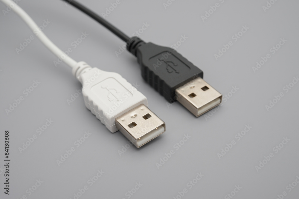 black and white usb cables on grey background black and white usb cables on grey background