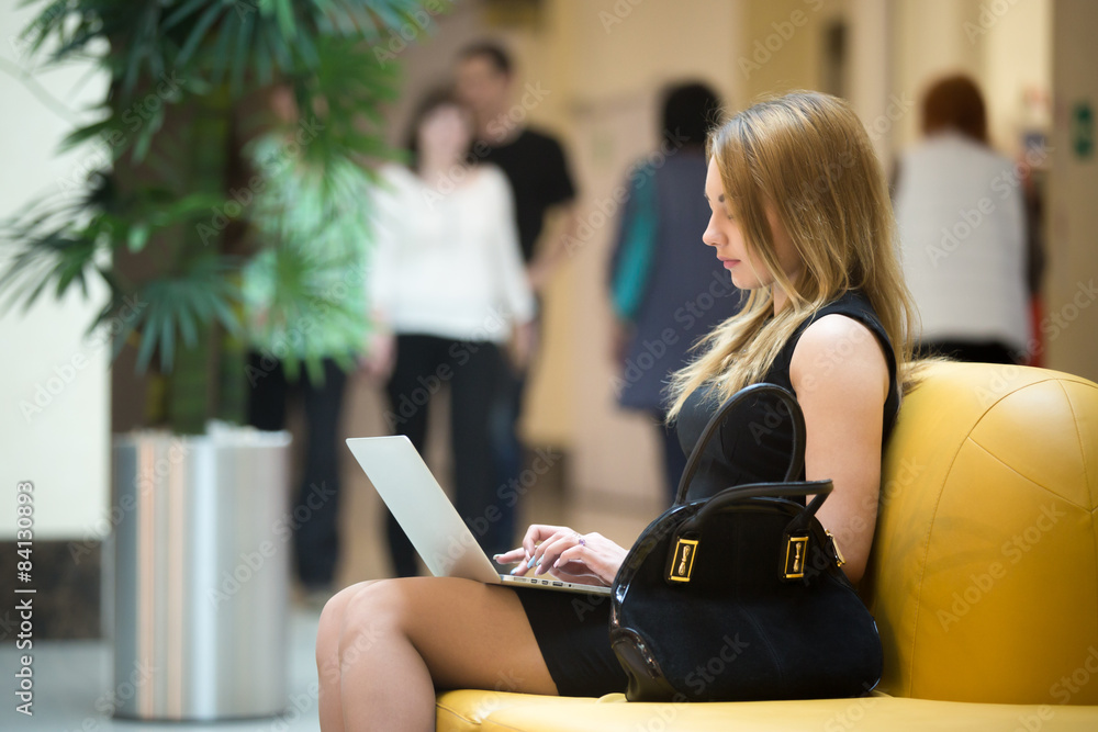 Fototapeta premium Young woman working on laptop