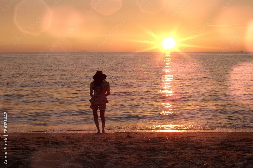 girl looking sunset on beach. 