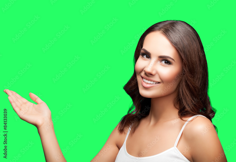 Woman in showing copyspace or something, on green chroma key bac Woman in showing copyspace or something, on green chroma key bac