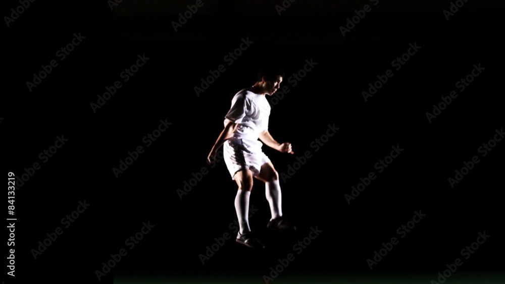 A shot of a soccer player dribbling a ball past defending players A shot of a soccer player dribbling a ball past defending players