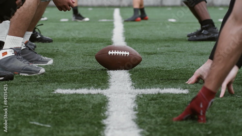 Opposing football teams line up for a play.