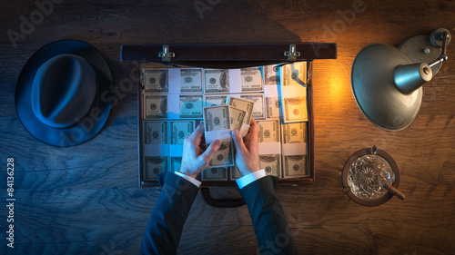 Rich businessman with dollar packs