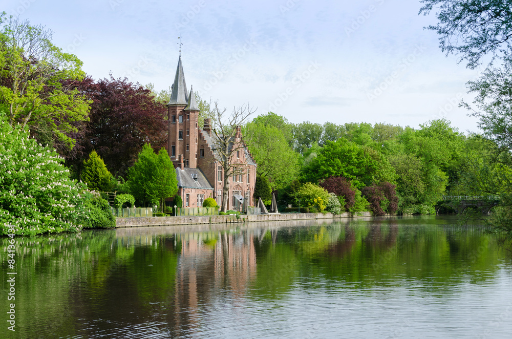 Flemish style building reflecting in Minnewater lake Flemish style building reflecting in Minnewater lake
