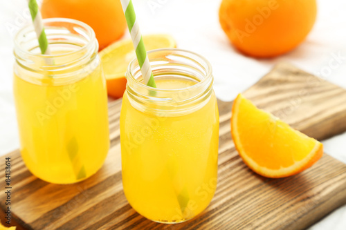 Orange juice in bottle on cutting board