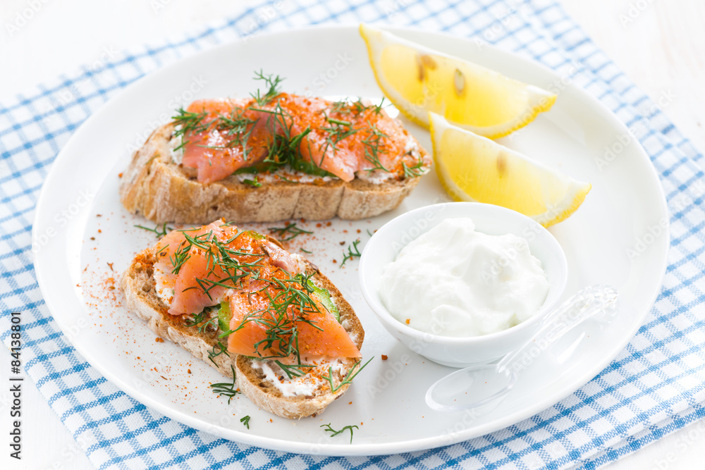 bread with salted salmon and cream cheese on a plate bread with salted salmon and cream cheese on a plate