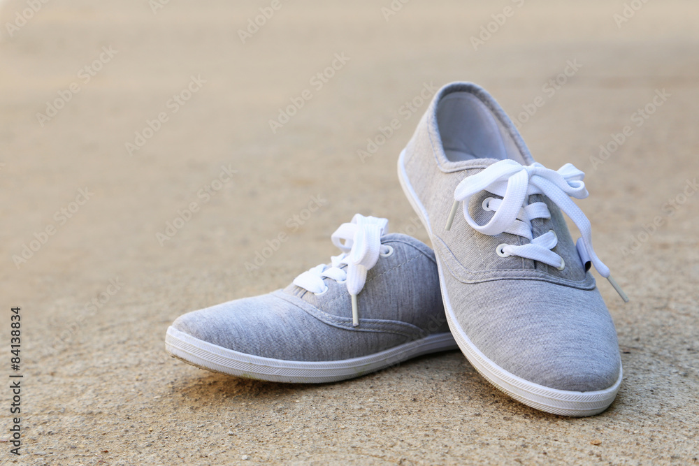 Naklejka premium Pair of grey shoes outdoors