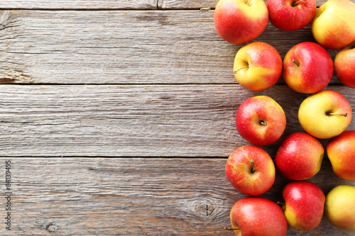 Red apples on grey wooden background