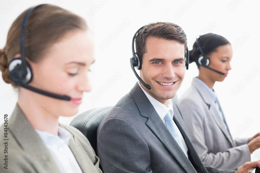 Business people with headsets using computers Business people with headsets using computers